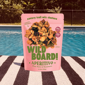 WildBoard Aperitivo savory trail mix clusters in a 3.5 ounce stand up pouch with 15g protein and 12g fiber callouts, made with pine nuts and rosemary, vegan and made with gluten free ingredients