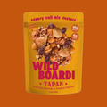 WildBoard TAPAS savory trail mix clusters with roasted chickpeas, Marcona almonds, smoked paprika, 15g protein, and 6g fiber in a golden resealable bag.